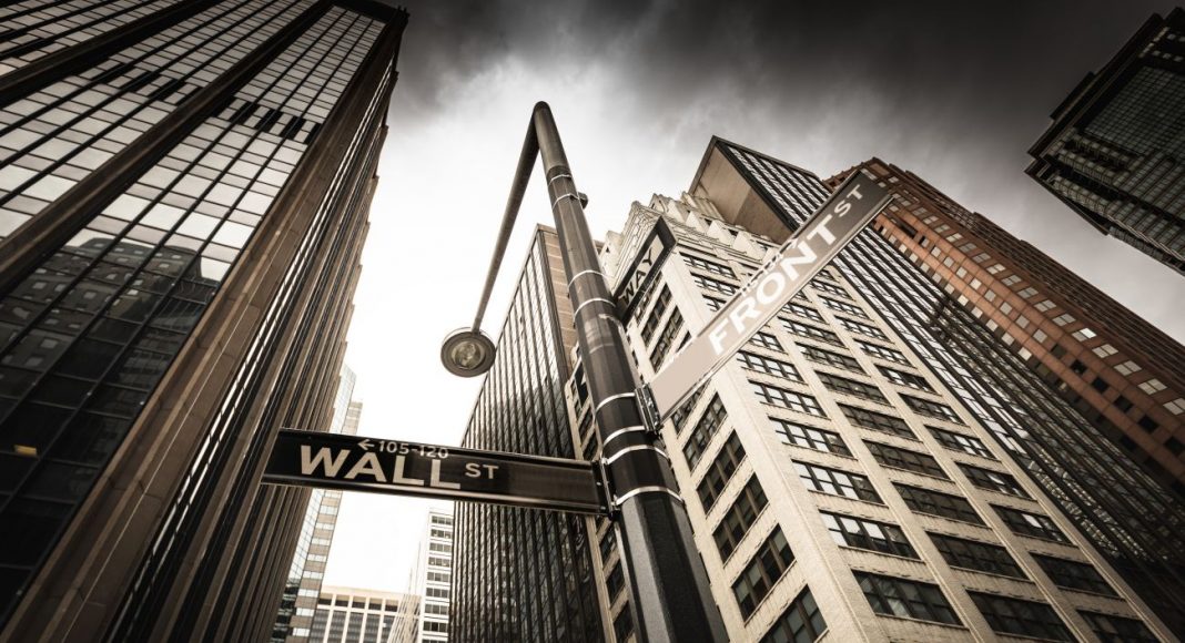 Manhattan office building and Wall St. sign