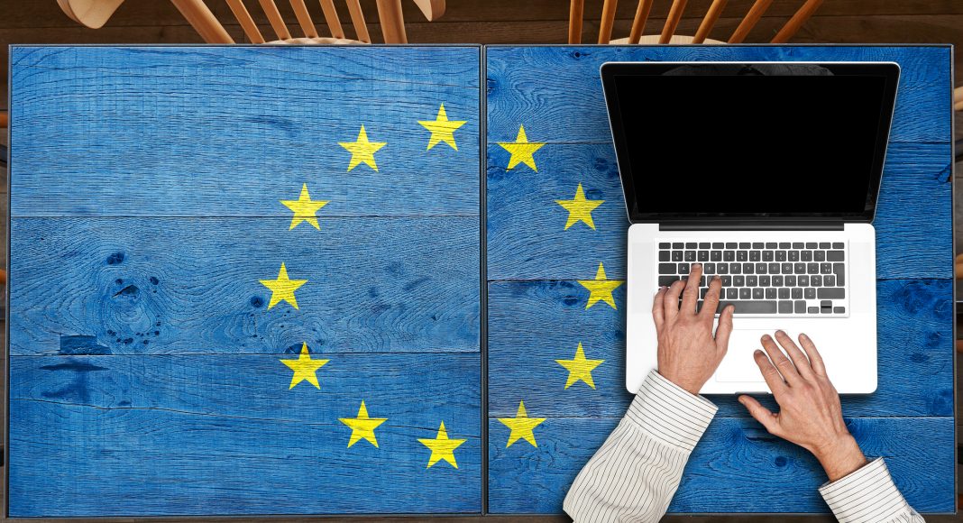 Europe flagged wooden Table with laptop