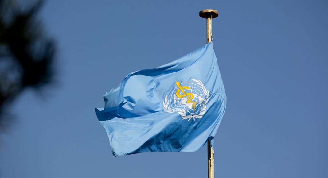 World Health Organization Headquarters and Flag. BLue flag with white globe and yellow snake on blue background.