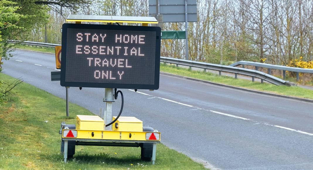 Road sign indicating essential travel only due to the Covid-19 lockdown