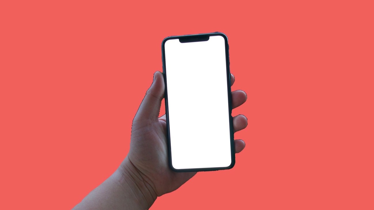 Female hand holding iphone 11 over red backdrop