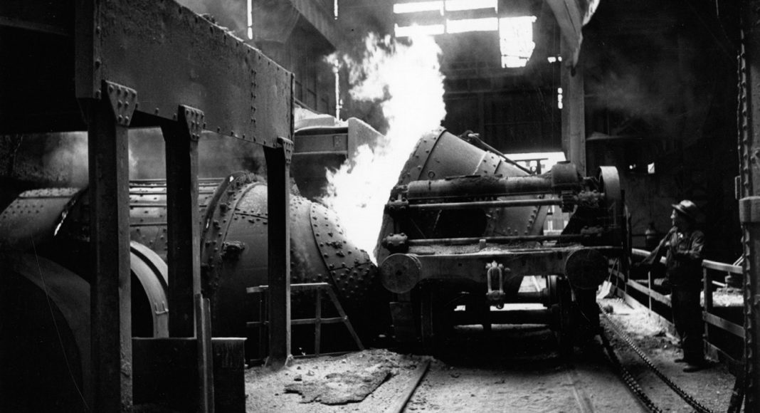 Worker working machinery in a steel foundry