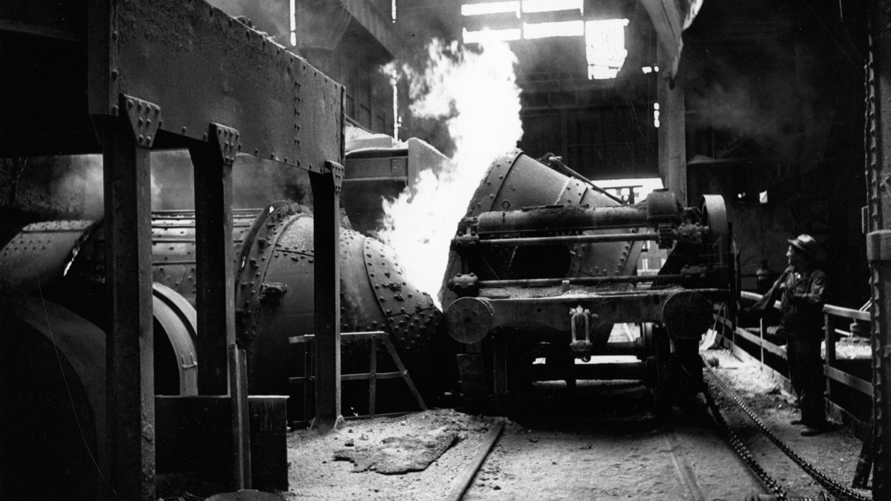 Worker working machinery in a steel foundry